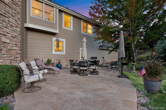 view of patio terrace at dusk