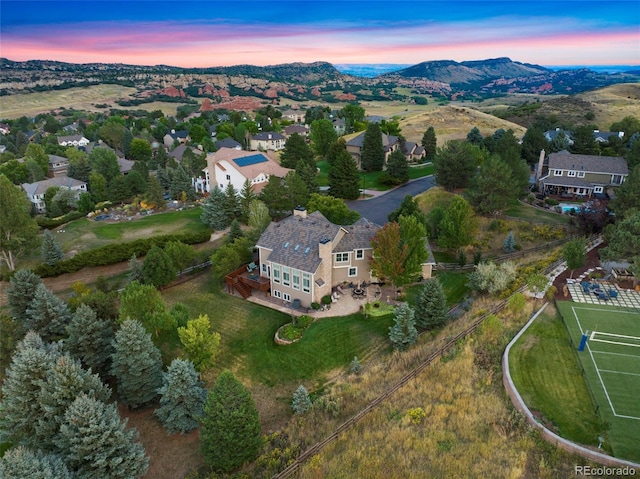 aerial view at dusk featuring a mountain view