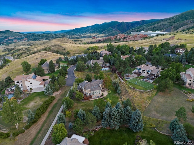 aerial view at dusk featuring a mountain view