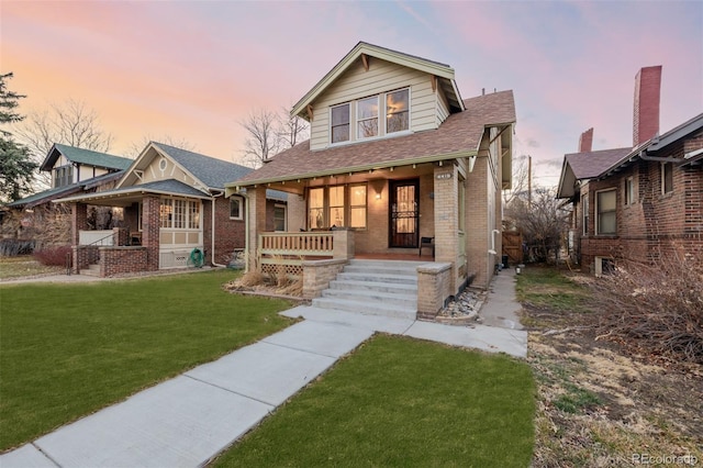 view of front of home featuring a yard and a porch