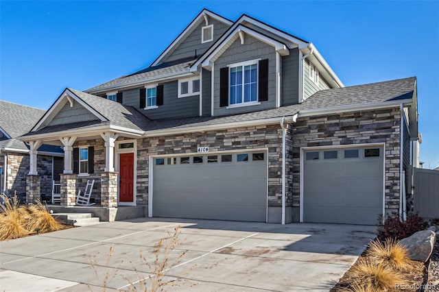 4104 N Picadilly Ct, Aurora, CO 80019 - craftsman house featuring driveway, covered porch, stone siding, and an attached garage