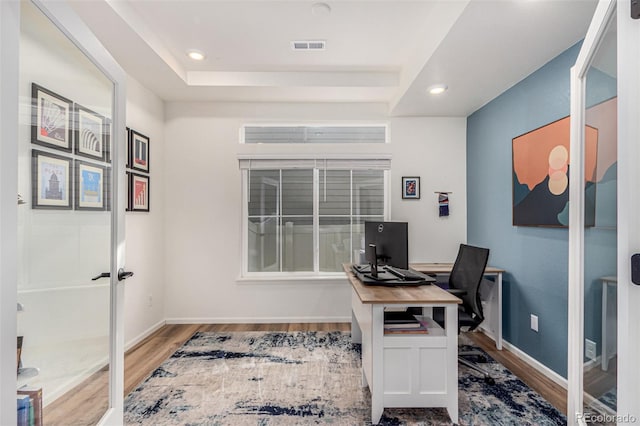 4104 N Picadilly Ct, Aurora, CO 80019 - office area featuring wood finished floors, a tray ceiling, and recessed lighting