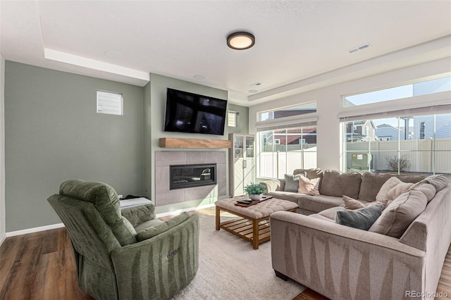 4104 N Picadilly Ct, Aurora, CO 80019 - living room with a fireplace, wood finished floors, and a raised ceiling