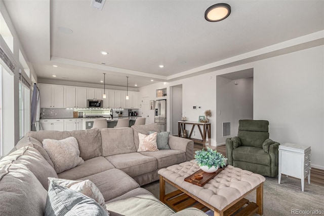 4104 N Picadilly Ct, Aurora, CO 80019 - living room featuring a raised ceiling and recessed lighting