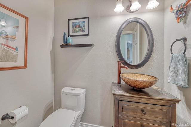 half bathroom with vanity and toilet