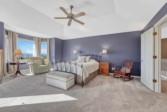 carpeted bedroom featuring vaulted ceiling, baseboards, and ceiling fan