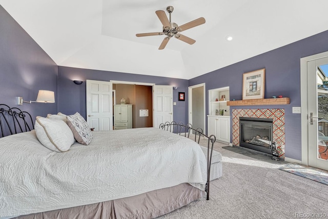 carpeted bedroom with lofted ceiling, a tiled fireplace, a ceiling fan, access to outside, and baseboards