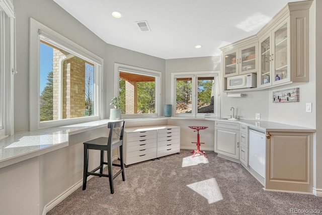 kitchen featuring light countertops, white appliances, visible vents, and carpet flooring