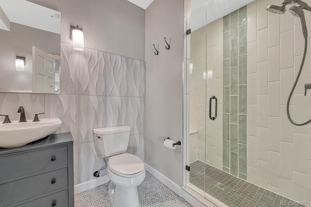 full bathroom featuring toilet, tile patterned flooring, vanity, a shower stall, and tile walls