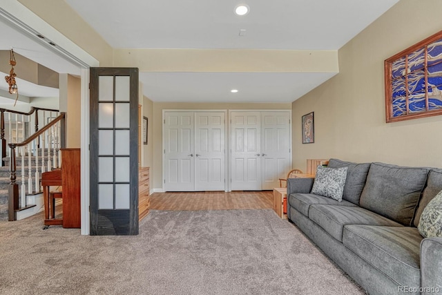 living room featuring carpet, stairway, and recessed lighting