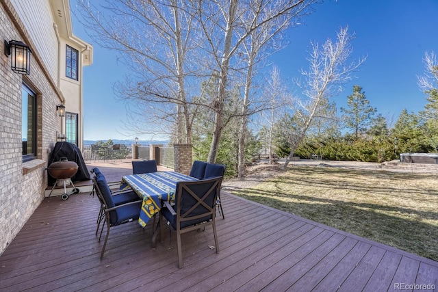 deck featuring a yard and outdoor dining space