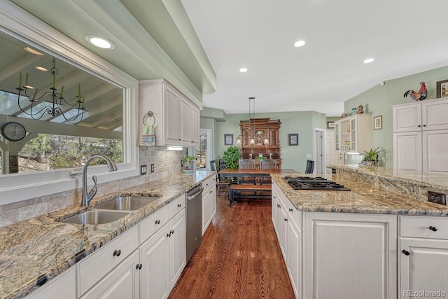 kitchen featuring stainless steel dishwasher, a sink, and white cabinetry