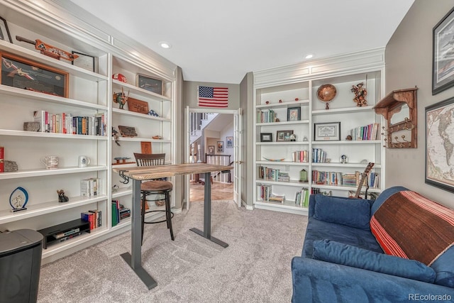 carpeted home office with built in shelves