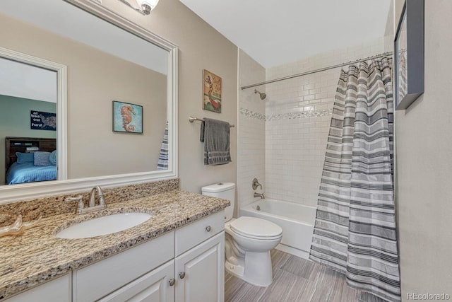 full bathroom featuring shower / bath combination with curtain, ensuite bath, vanity, and toilet