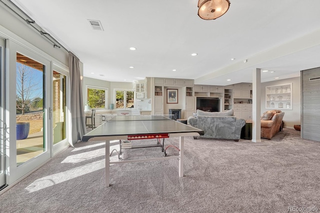 game room with visible vents, built in features, carpet floors, a fireplace, and recessed lighting