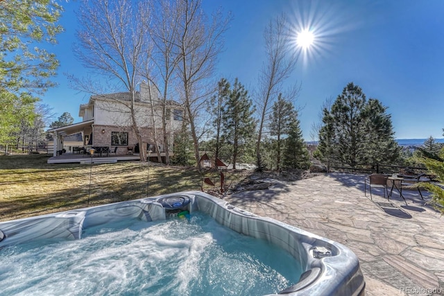 view of swimming pool featuring a wooden deck and an outdoor hot tub