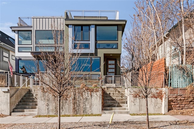 view of front of property featuring stairs and stucco siding