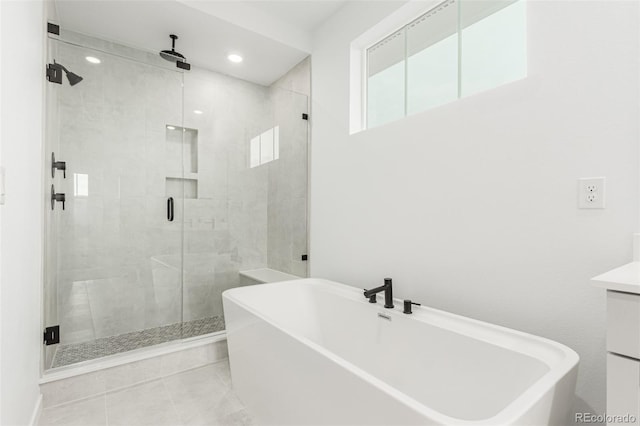1826 Hickory Ave, Erie, CO 80516 - bathroom featuring a freestanding tub, a shower stall, vanity, recessed lighting, and tile patterned flooring