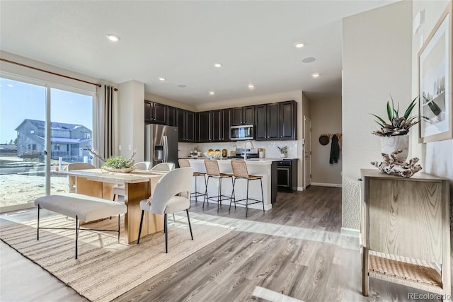 dining room with sink and light hardwood / wood-style floors