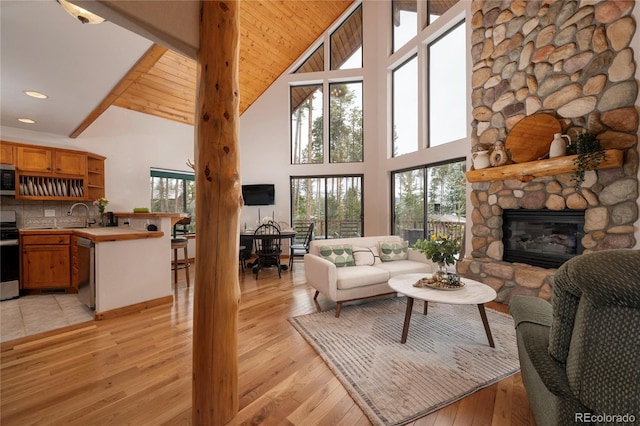507 Gcr 4980, Grand Lake, CO 80447 - living area featuring high vaulted ceiling, a stone fireplace, light wood finished floors, and recessed lighting
