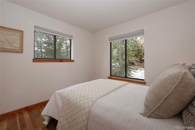 507 Gcr 4980, Grand Lake, CO 80447 - bedroom featuring multiple windows, wood finished floors, and baseboards