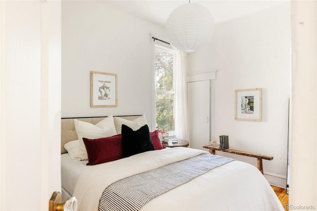 321 Fox St, Denver, CO 80223 - bedroom featuring multiple windows, wood finished floors, and baseboards
