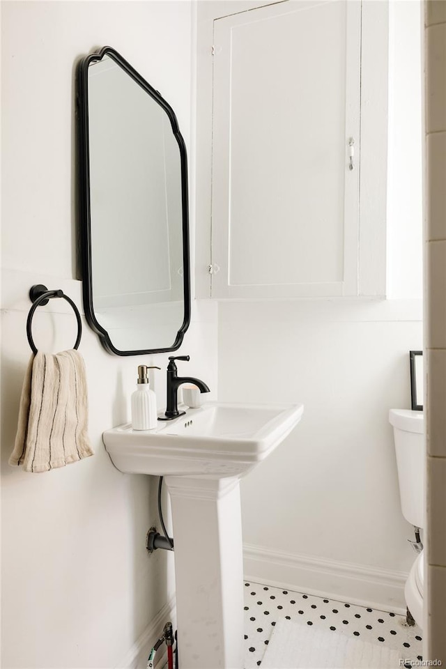 321 Fox St, Denver, CO 80223 - bathroom featuring toilet and baseboards
