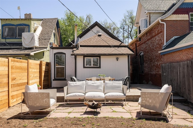 321 Fox St, Denver, CO 80223 - back of house featuring an outdoor hangout area, a fenced backyard, a patio area, and roof with shingles