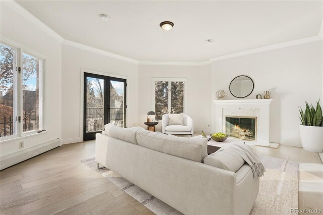 living room with a fireplace, visible vents, french doors, light wood finished floors, and crown molding