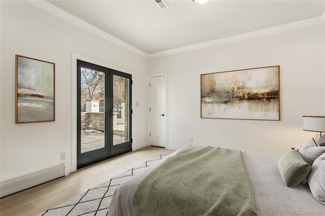 bedroom featuring light wood finished floors, baseboards, ornamental molding, access to exterior, and french doors