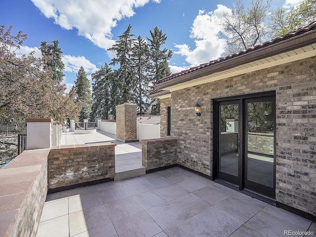 view of patio with a gate and fence