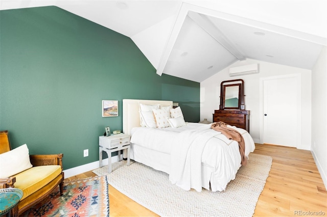 bedroom featuring a wall mounted air conditioner, light wood-type flooring, and baseboards