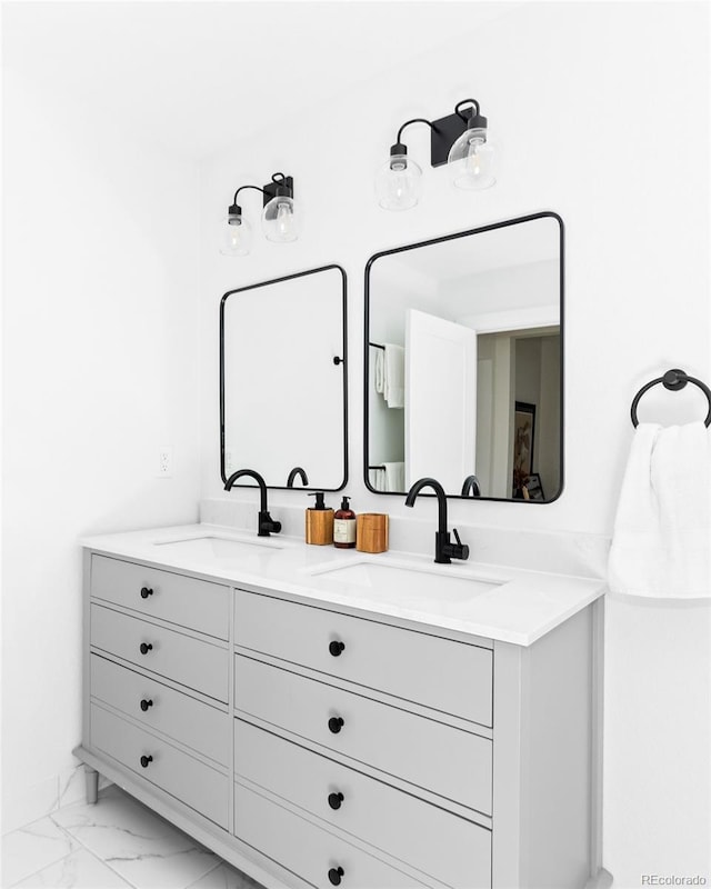 bathroom with marble look tile flooring and double vanity