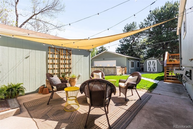 view of patio / terrace featuring a shed, an outdoor structure, and fence