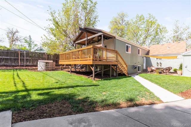 rear view of house with stairway, a wooden deck, and a patio