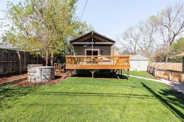 rear view of house featuring a deck, a shed, and an outbuilding