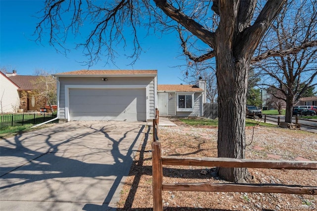 ranch-style home with a garage, driveway, fence, and a chimney