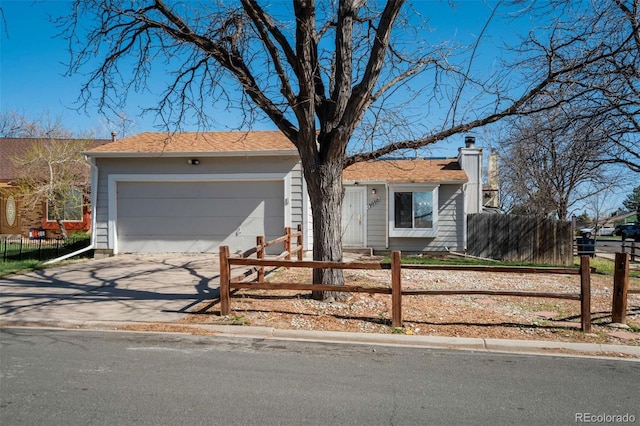 single story home featuring a chimney, a fenced front yard, a garage, and driveway