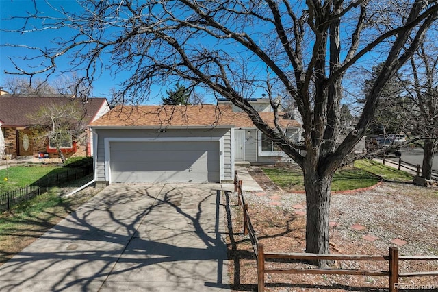 view of front of property with a garage, aphalt driveway, roof with shingles, and fence