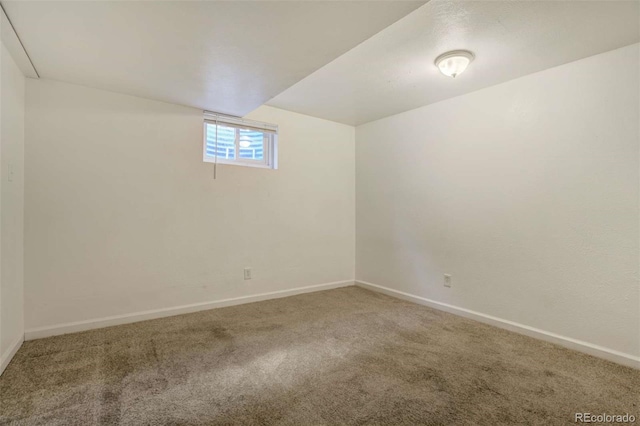 below grade area with baseboards and carpet
