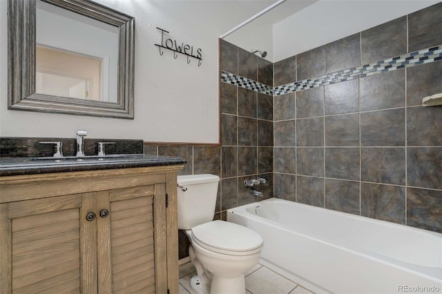 bathroom featuring toilet, tile walls, vanity, shower / bath combination, and tile patterned floors