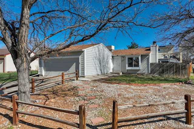 view of front of property featuring fence and driveway