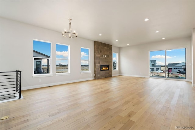 unfurnished living room with recessed lighting, light wood-style floors, and a tile fireplace