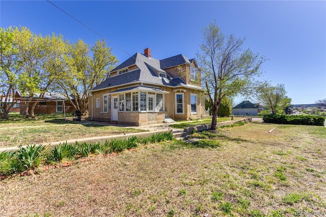 1601 San Pedro Ave, Trinidad, CO 81082 - rear view of house with a chimney and a lawn