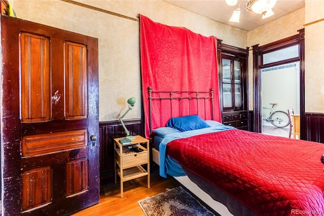 1601 San Pedro Ave, Trinidad, CO 81082 - bedroom with wainscoting and wood finished floors