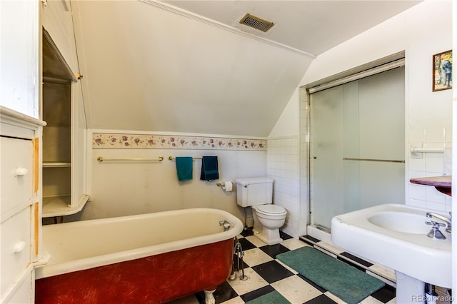 1601 San Pedro Ave, Trinidad, CO 81082 - full bath featuring toilet, visible vents, tile patterned floors, vaulted ceiling, and a freestanding bath