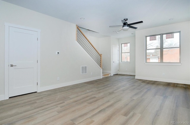 unfurnished living room featuring ceiling fan and light wood-type flooring