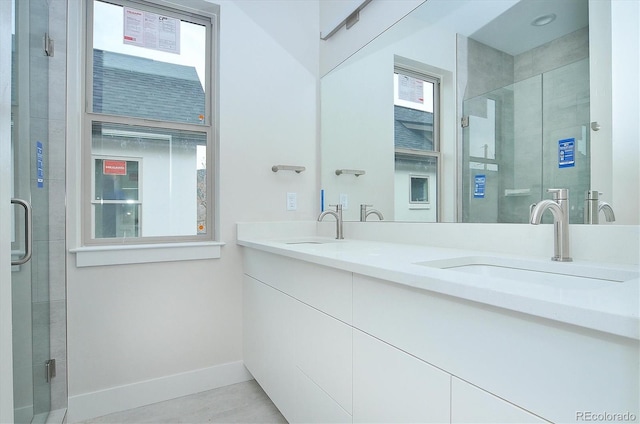 bathroom with vanity and a shower with shower door