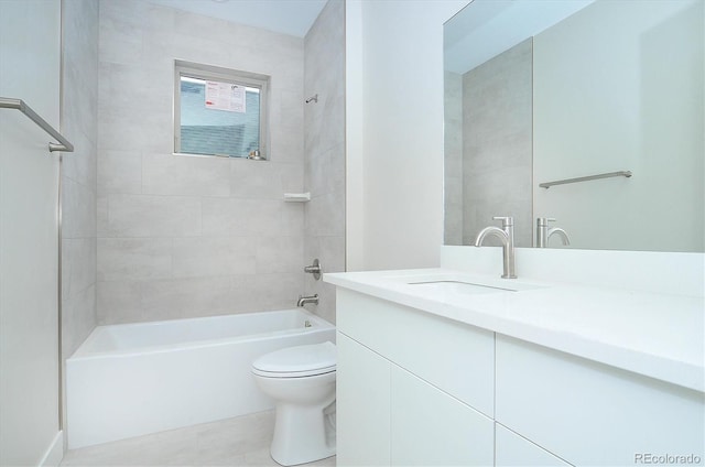 full bathroom with toilet, vanity, and tiled shower / bath