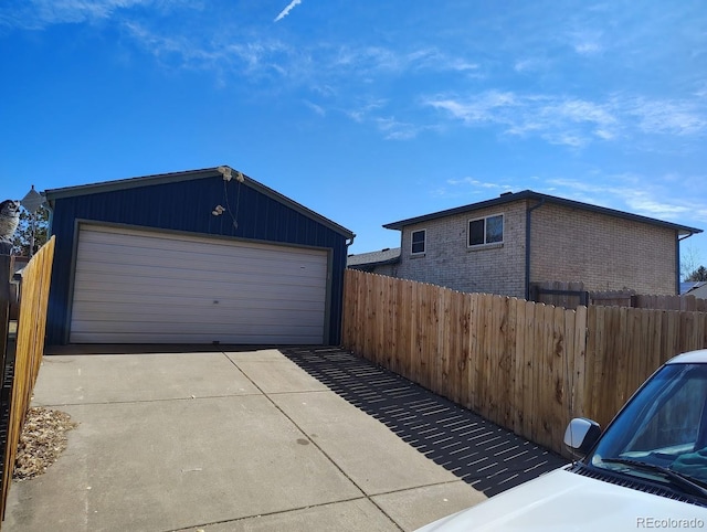 detached garage featuring fence